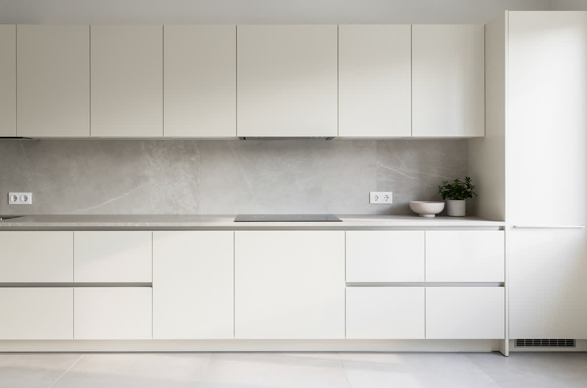 Bright modernised kitchen with pale cabinets and stone counters, framed as a listing photograph