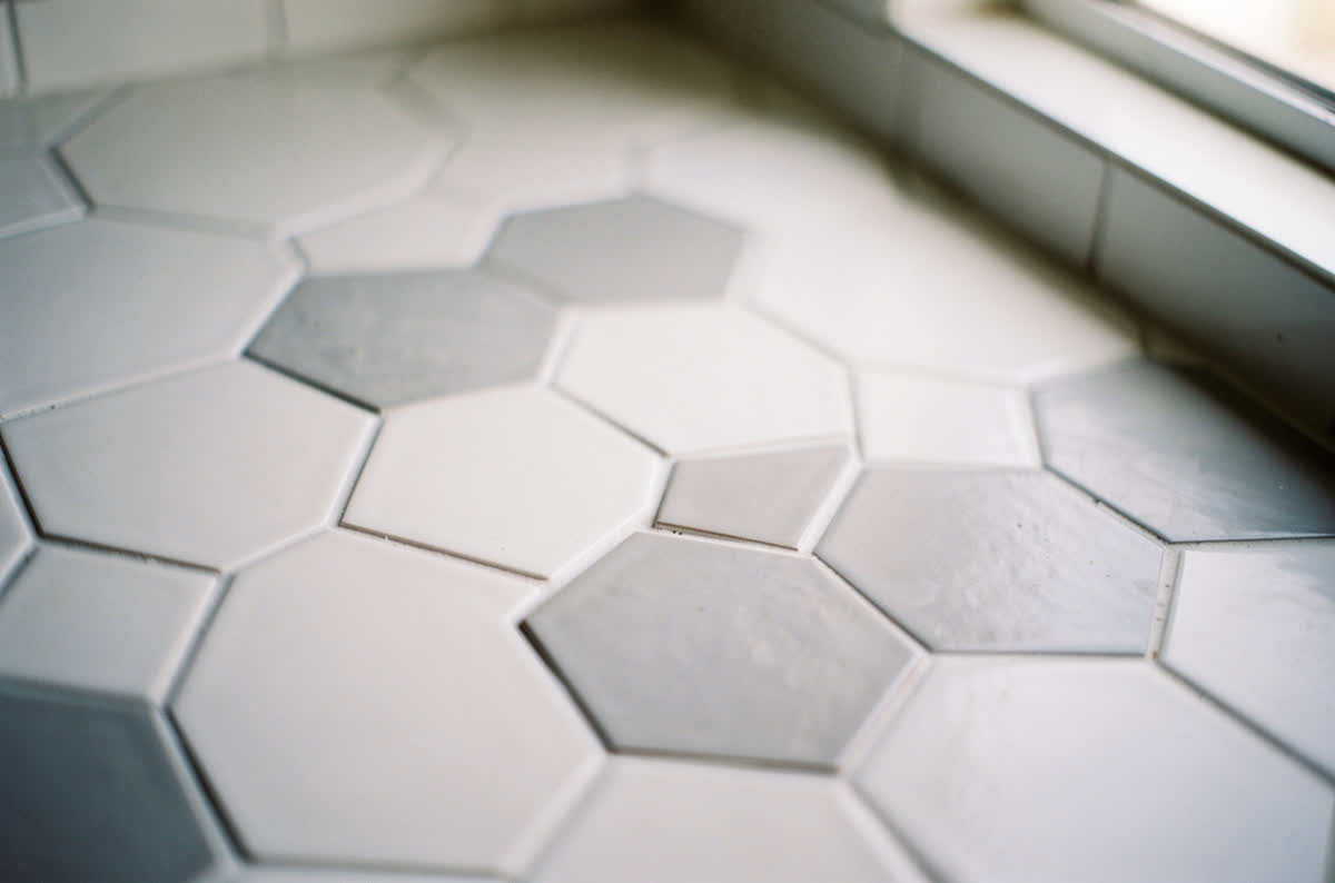 Matte white and soft gray hexagon tile with crisp geometric edges