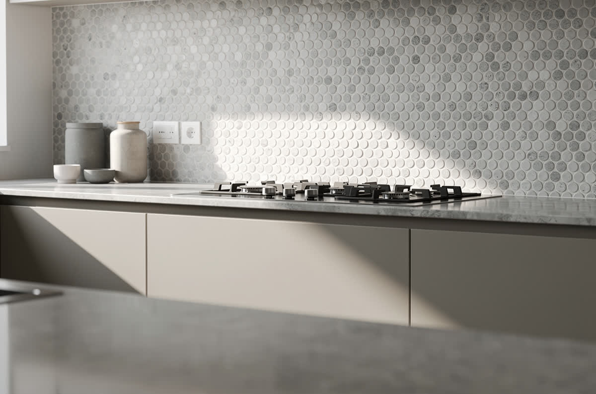Small circular penny tile backsplash in soft white and gray tones