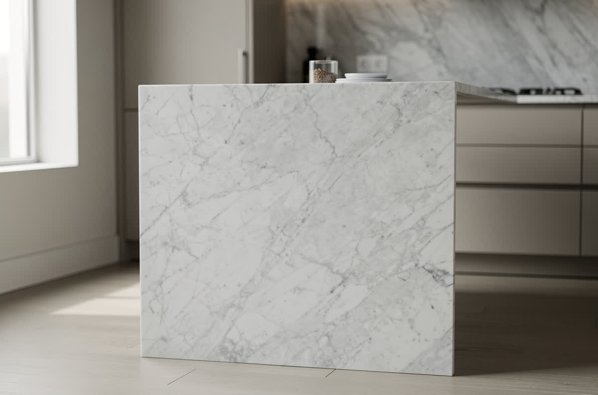 Kitchen island with a white marble countertop cascading down both ends to the floor