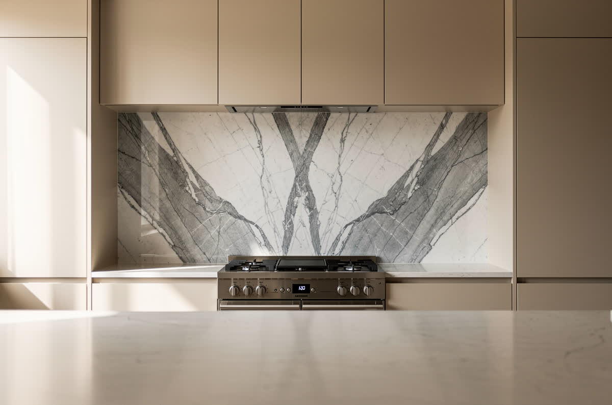Full-height bookmatched marble slab wall behind a kitchen range, veining mirrored across the seam