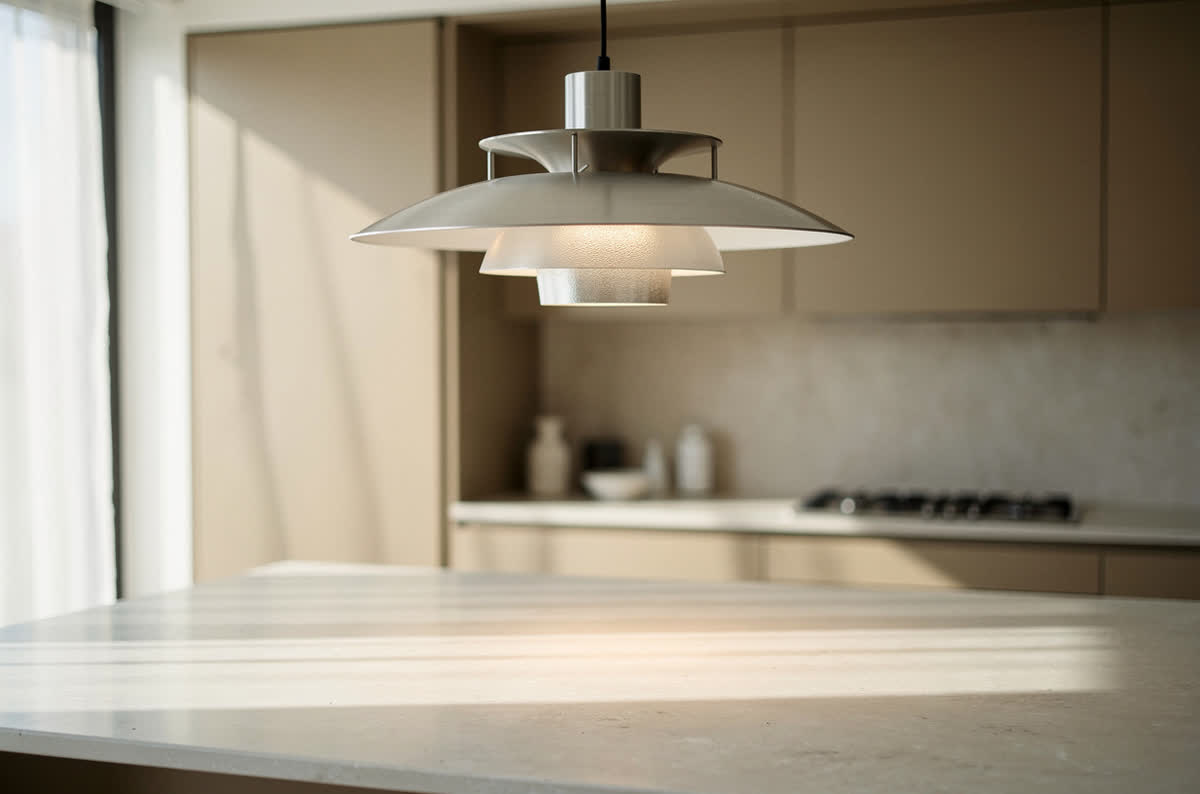 Sculptural pendant light hanging above a kitchen island like a piece of functional art