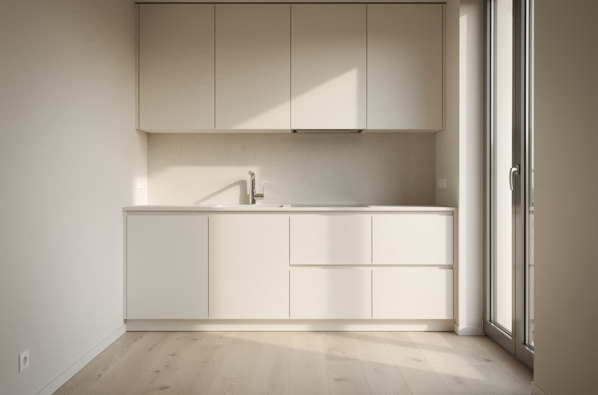 Small kitchen made to feel larger with pale uninterrupted surfaces and one tall window