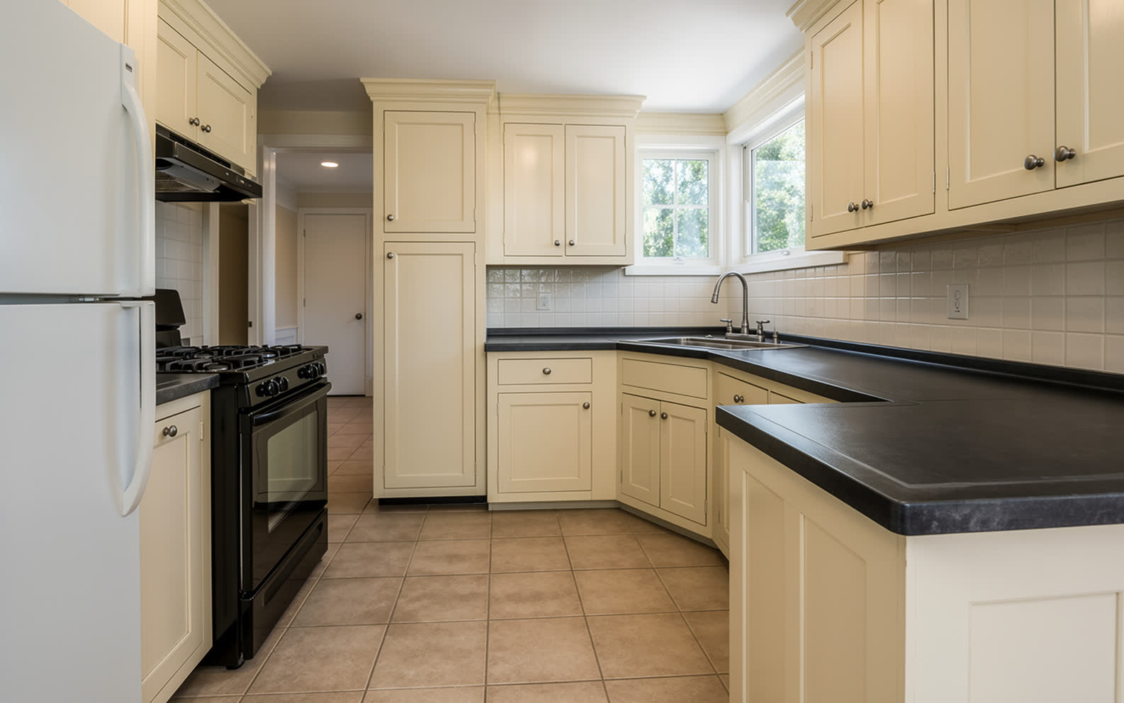 The same kitchen with every door repainted warm off white