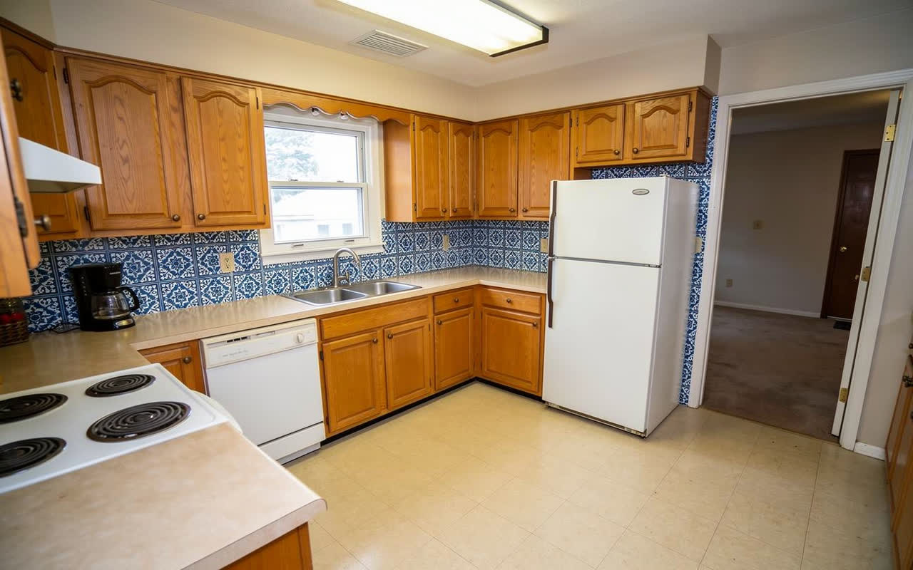 The same kitchen with blue and white patterned cement tile on the backsplash