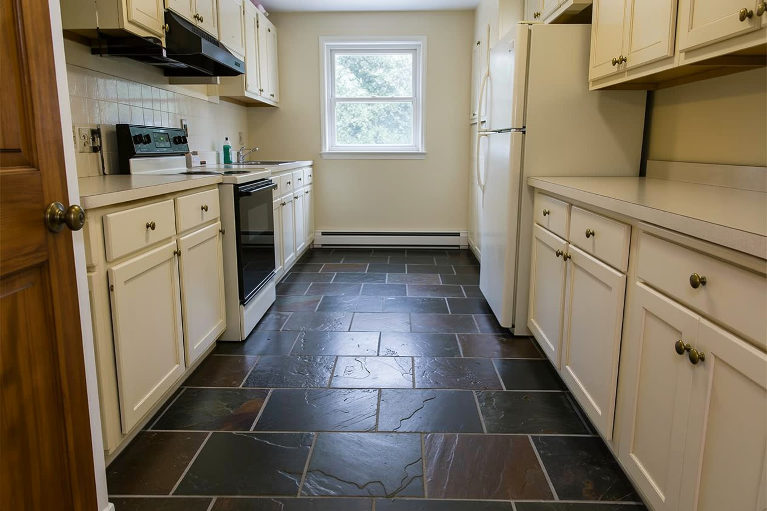 The same kitchen with a dark charcoal slate floor